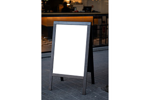 Blank A-frame sidewalk sign standing, a Background Photo by volodymyrshtun13795