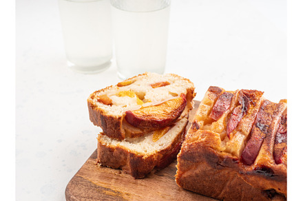 Peach cake loaf on wooden cutting
