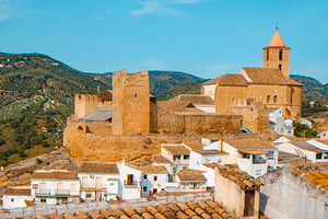 view of Iznajar Castle overlooking the town, in Spain, a Photo by Nito