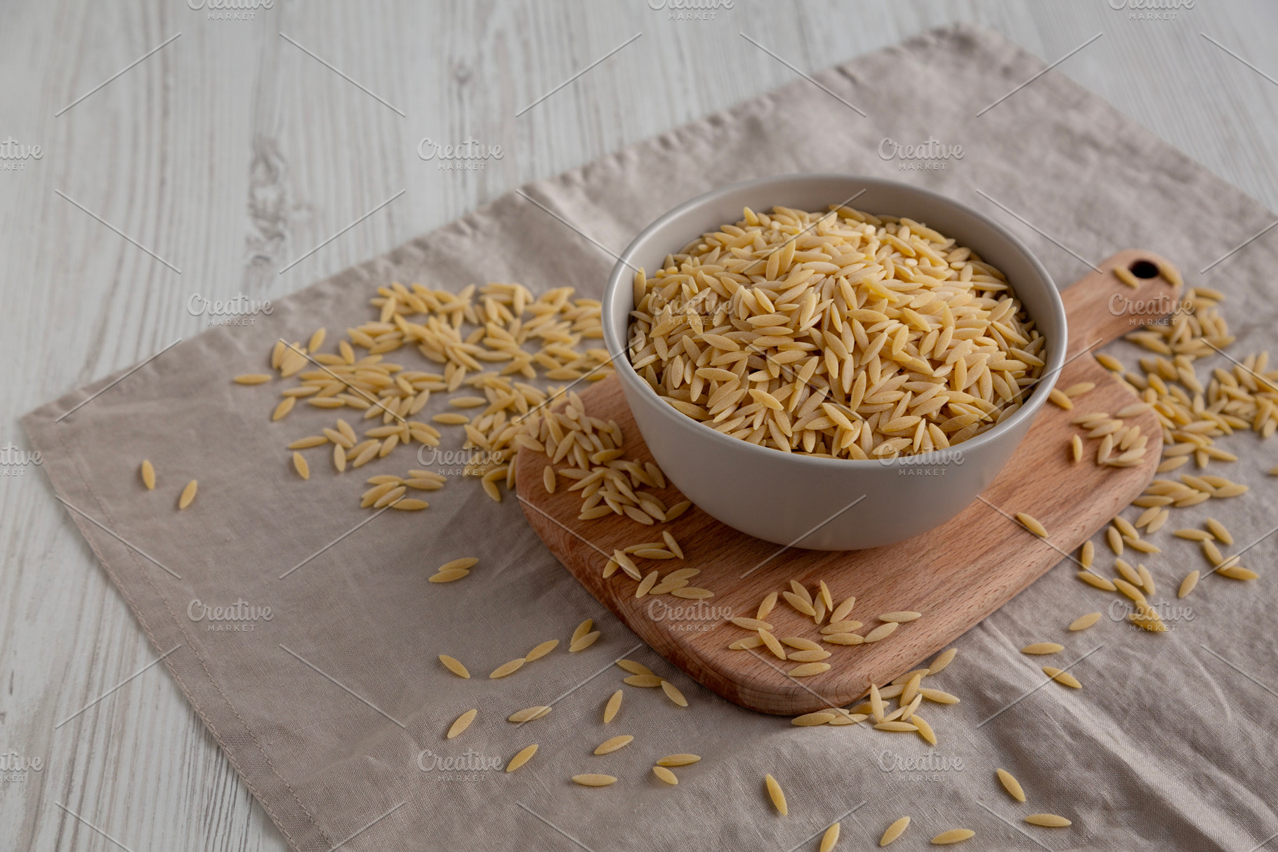 Organic Dried Orzo Pasta in a Bowl, side view. Copy space., a Food & Drink Photo by LiudmylaChuhunova