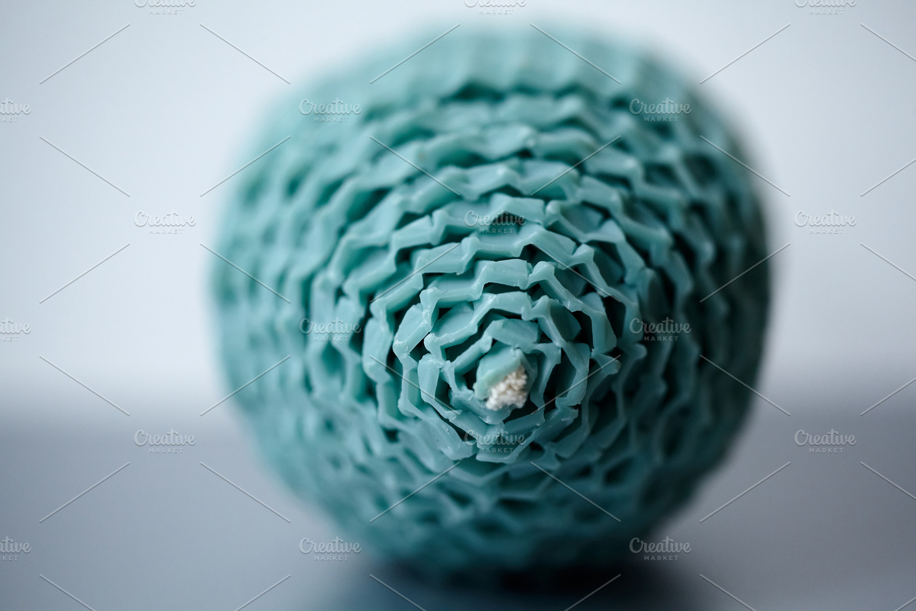 Extreme macro close-up of a teal beeswax egg-shaped candle texture and wick., a Holiday Photo by Rohan Photography