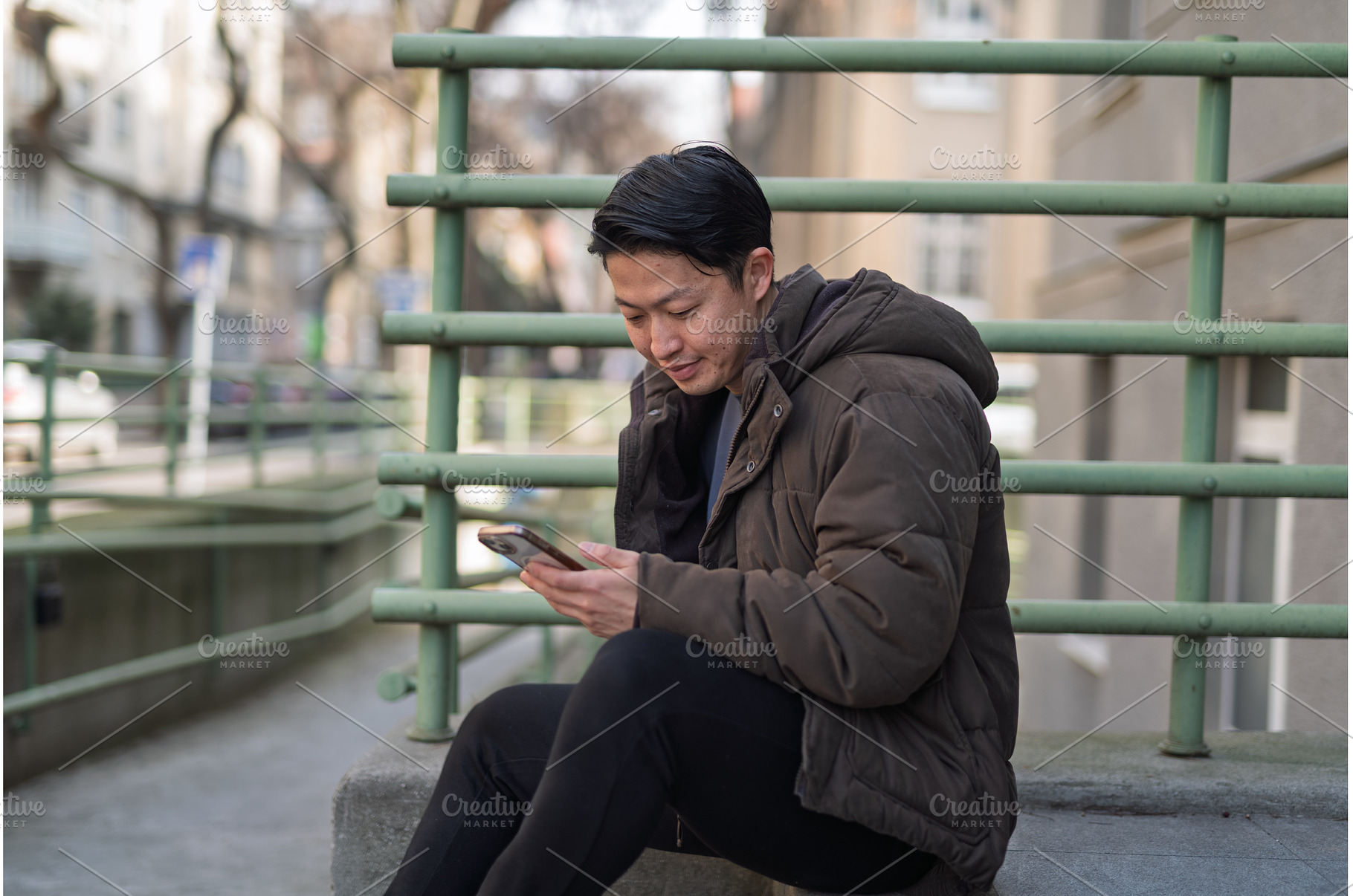 Young Asian man sitting on street, a Person Photo by HalfPoint