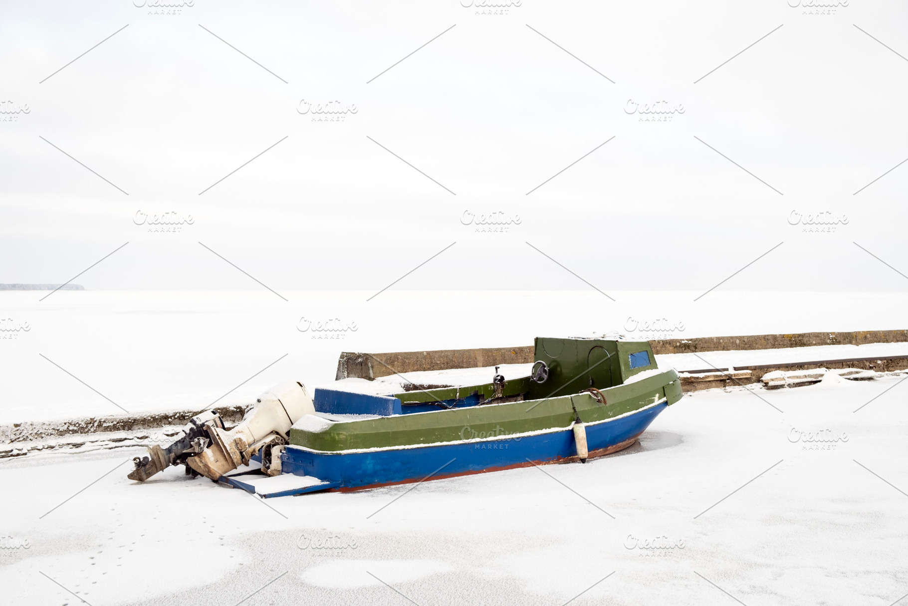 Lonely motorboat in a frozen harbour, a Transportation Photo by BOOCYS
