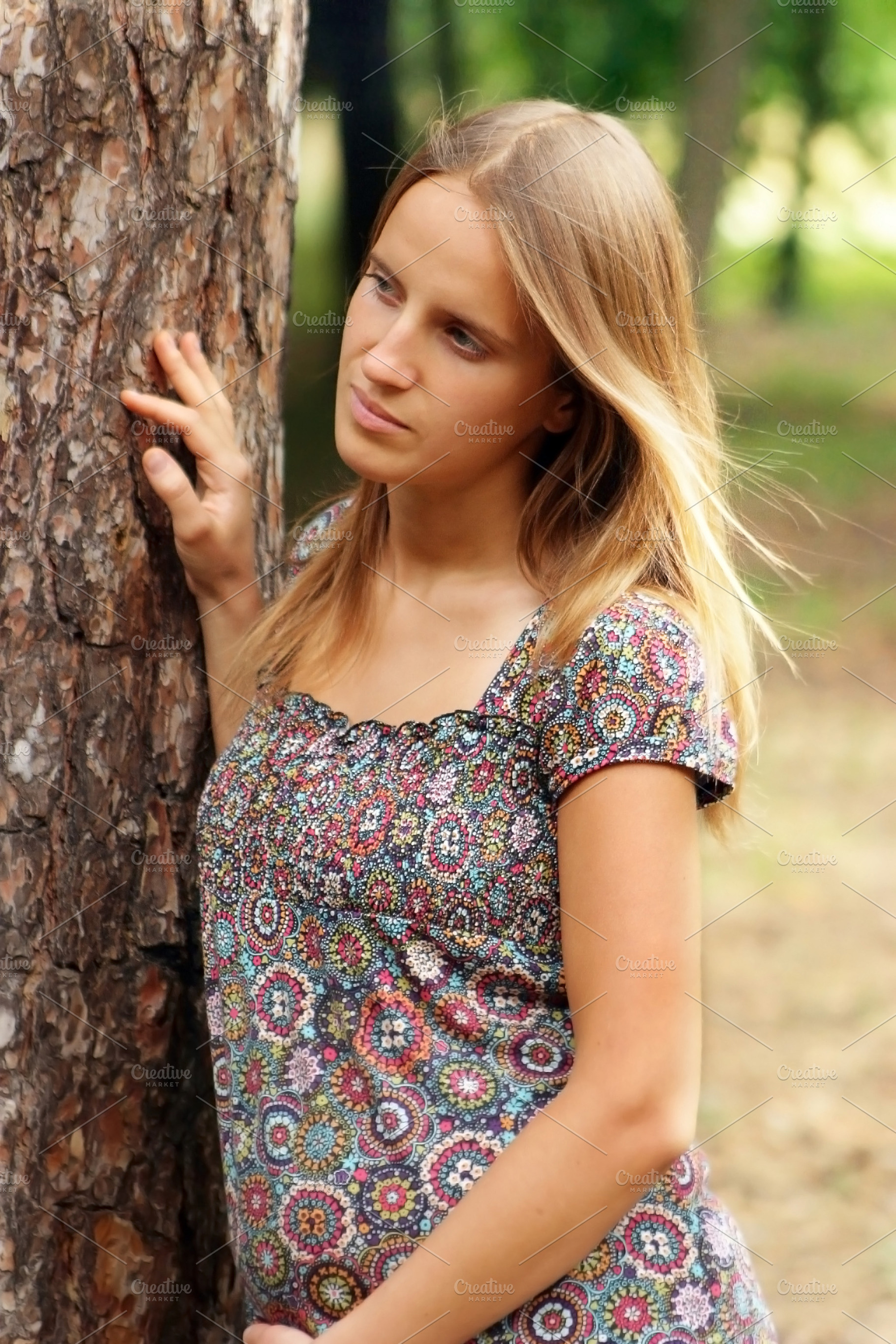 Young woman touch the tree, a Photo by saiko3p