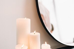 Candles by the mirror featuring candle, white, and light
