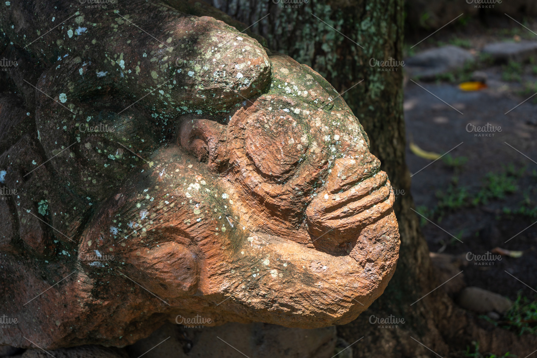 Stone tiki statue in Atuona, Hiva Oa, Marquesas Islands, French, a Photo by GoodGoods