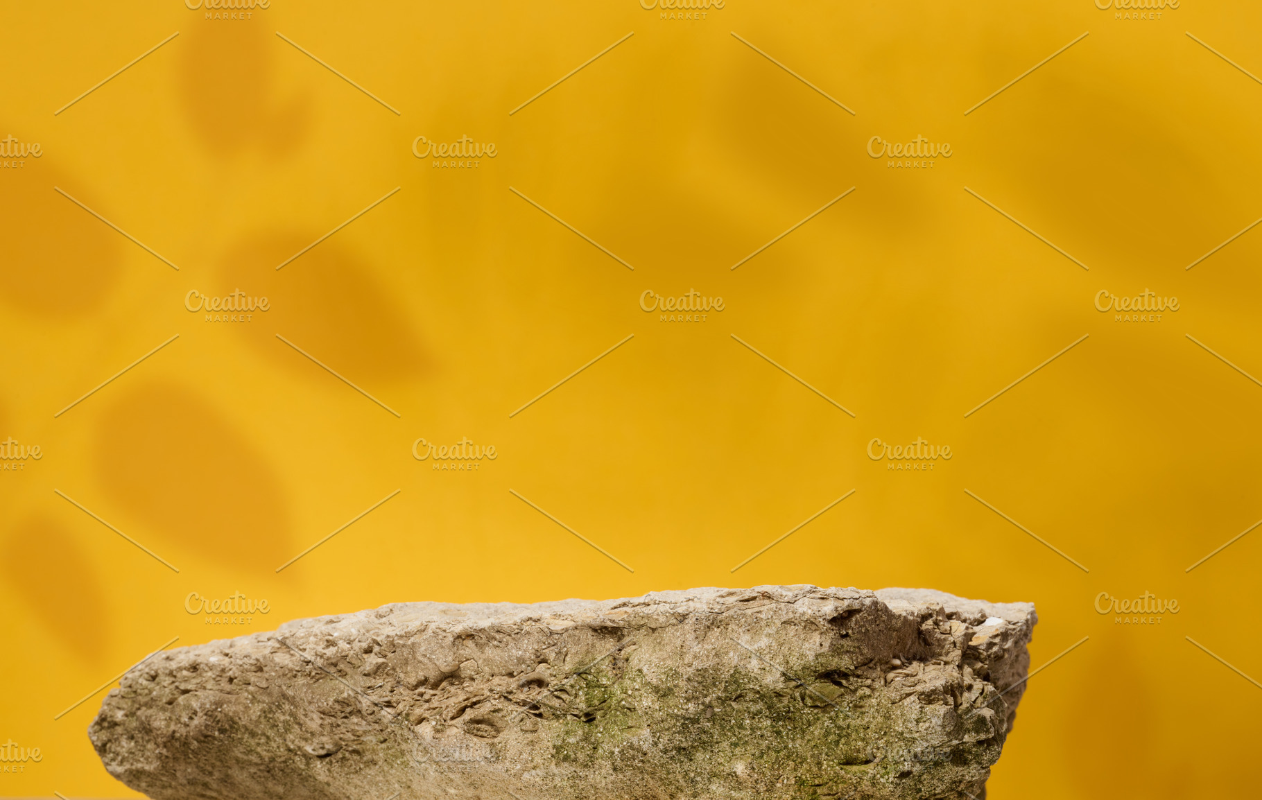 Stones on yellow background, stage for advertising and product d, a Background Photo by ndanko