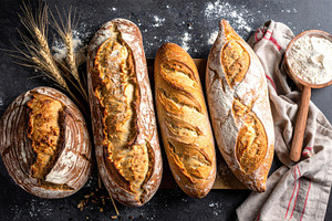 Artisan Sourdough Loaves on Rustic Dark Table, a Food & Drink Photo by Davizro's Market