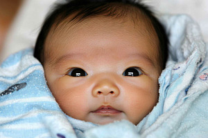 Newborn chinese baby sleeping peacef, a Photo by Dvoevnore photos