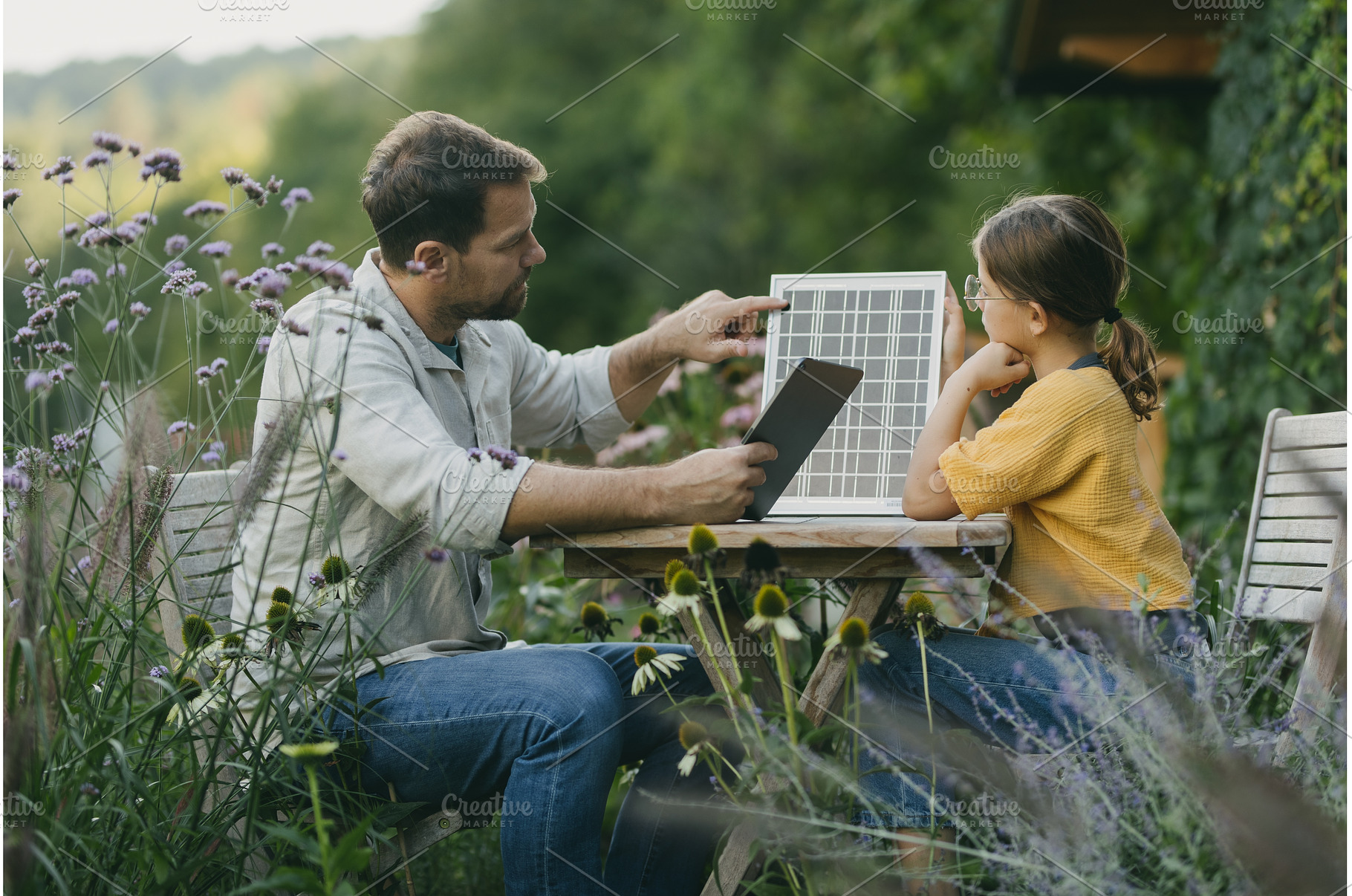 Father teaching daughter about solar, a School & Education Photo by HalfPoint