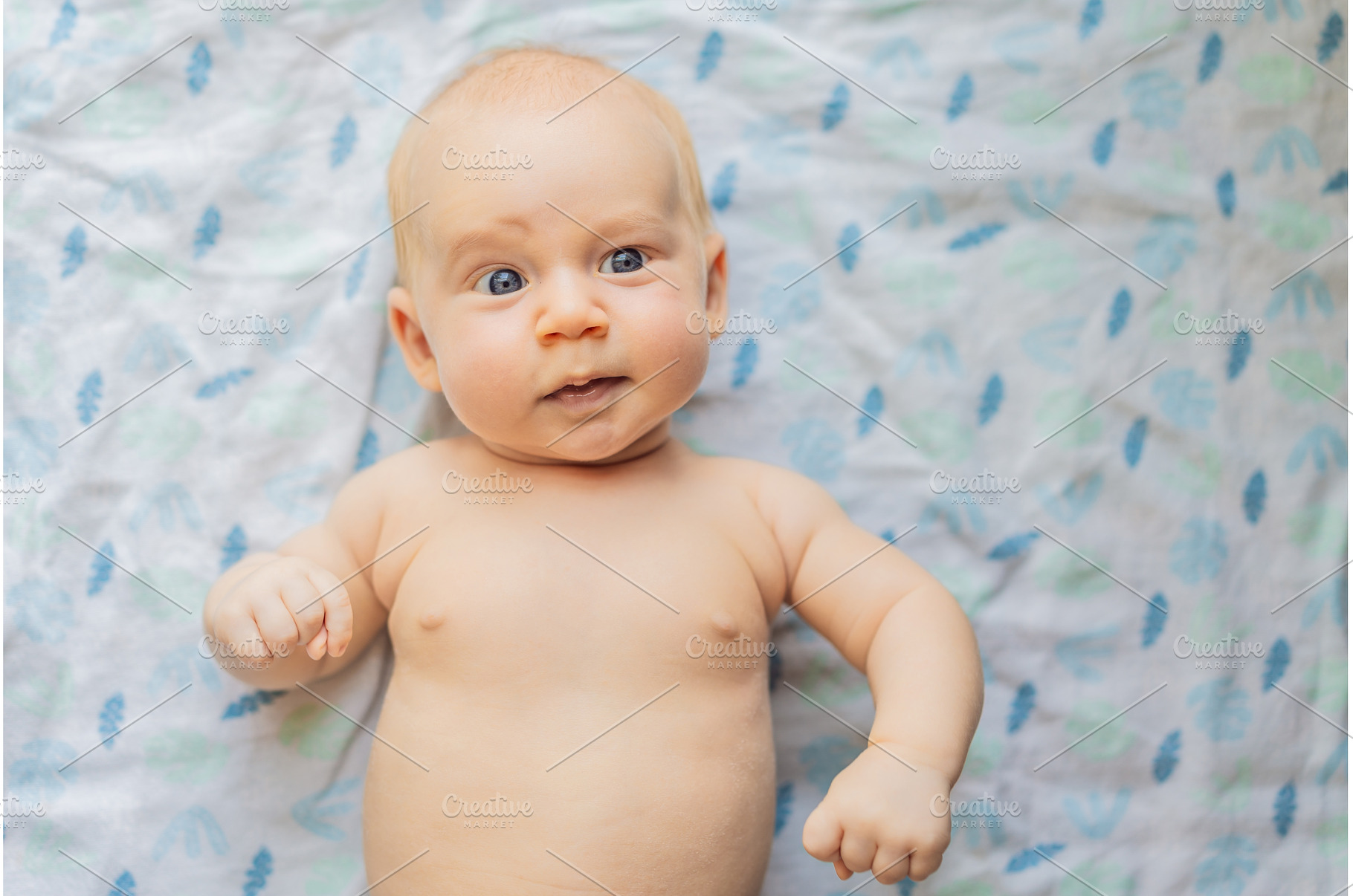 Curious baby lying on a soft blanket, a Person Photo by Elizaveta Galitskaya