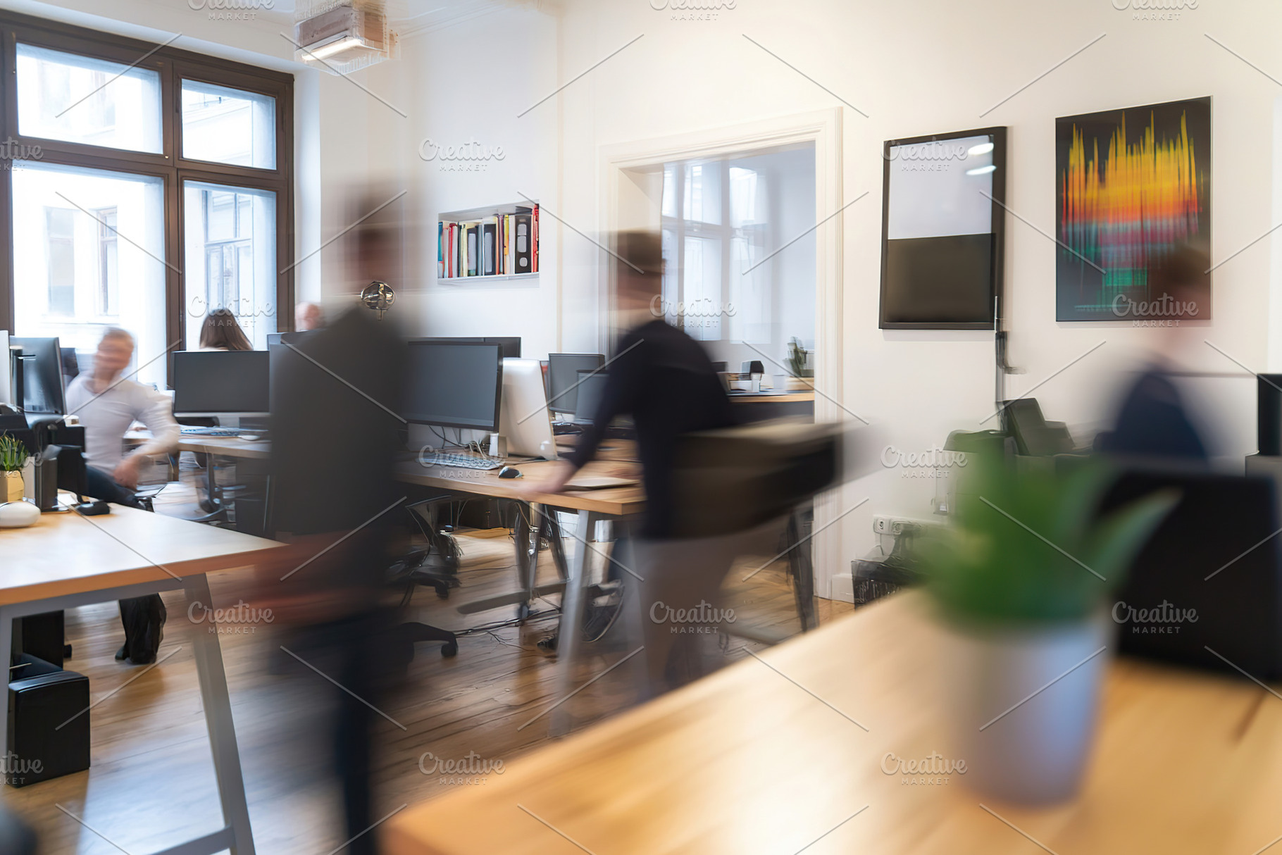 Dynamic office environment showcasing teamwork and collaboration, a Photo by AlyaAnd