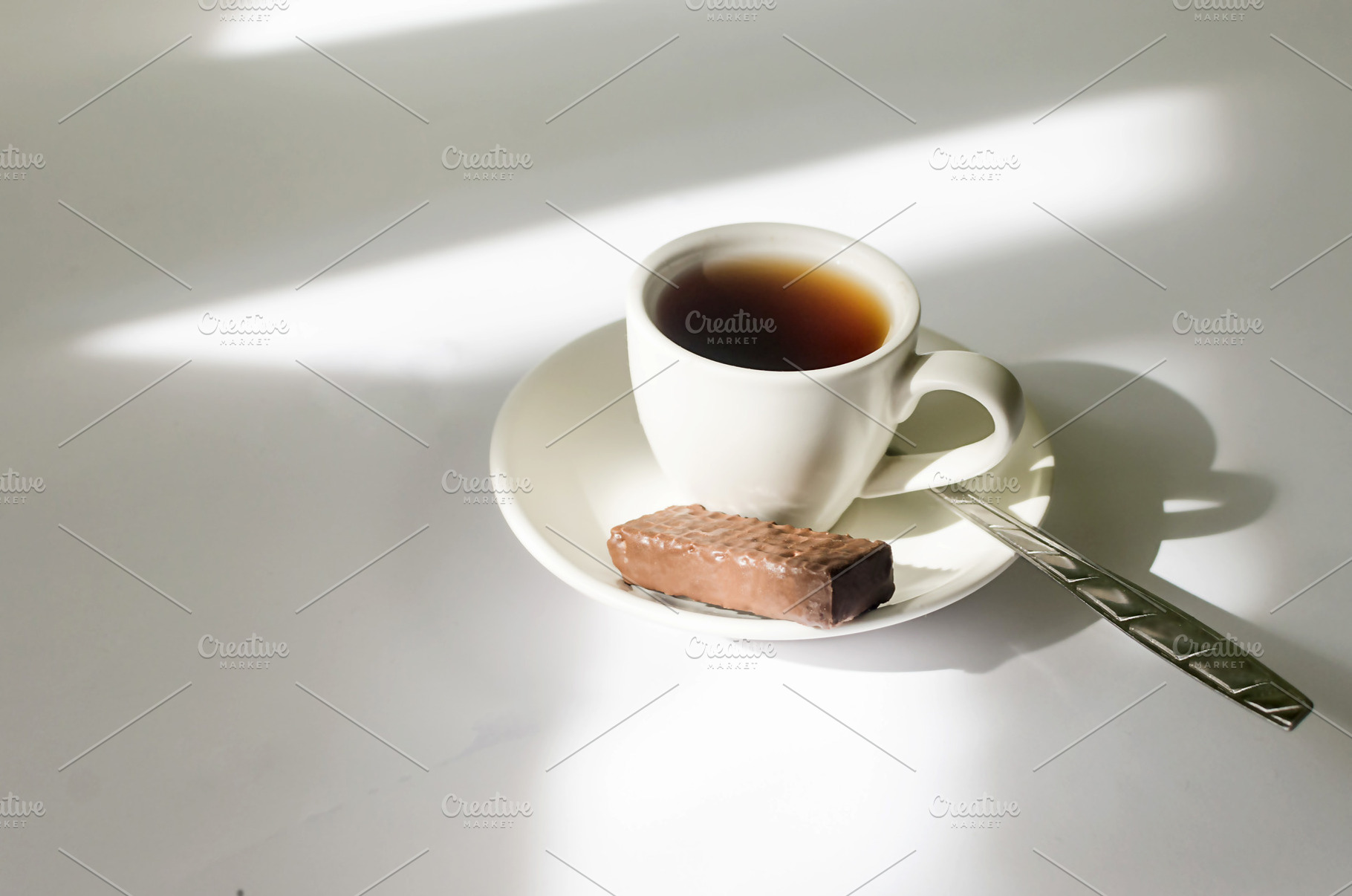 A cup of hot coffee in the morning sunlight  on white table., a Food & Drink Photo by vimart