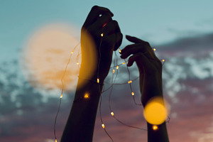Silhouette of hands holding lights