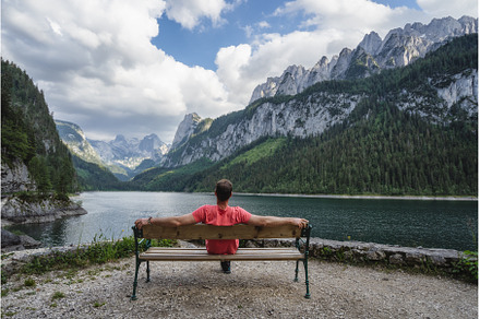 Man relaxing on bench in front of, a Person Photo by Igor Tichonow