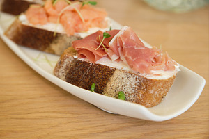 Assorted gourmet bruschettas with smoked salmon and prosciutto on white platter, a Food & Drink Photo by Rohan Photography