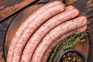 Uncooked sausage on a wooden board, a must have ingredient for d, a Food & Drink Photo by composter-box@mail.ru