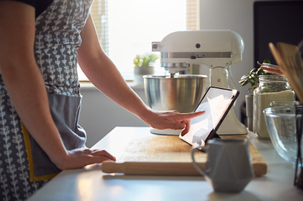 Side view woman using touch screen o stock photo containing baking and woman, a Food & Drink Photo by Southworks