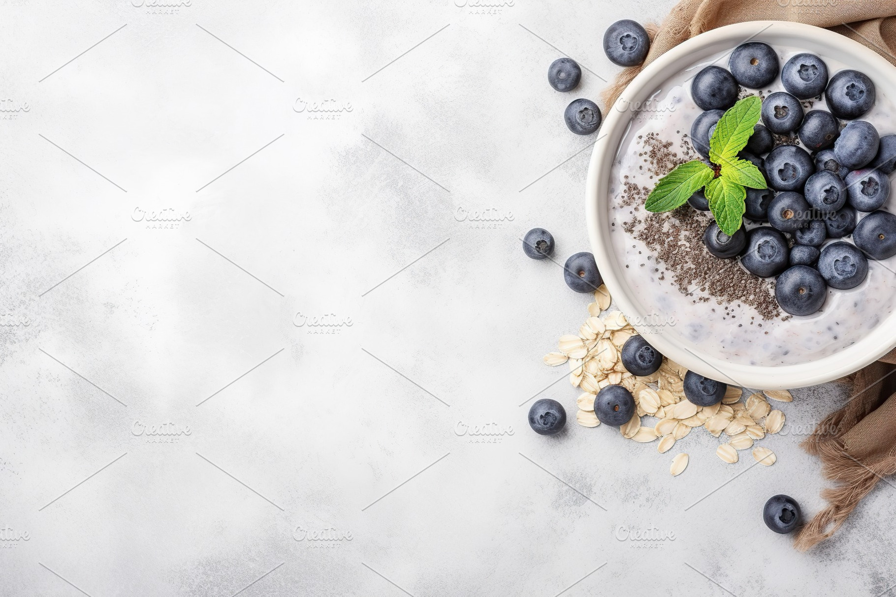 Chia pudding with blueberry and granola in bowl on grey background, a Food & Drink Photo by AlyaAnd