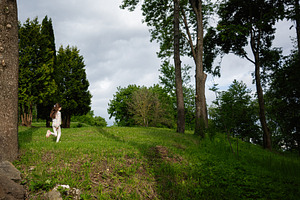 Young girl playing outdoors surrounded by green trees and natural landscape, a Person Photo by AS photostudio