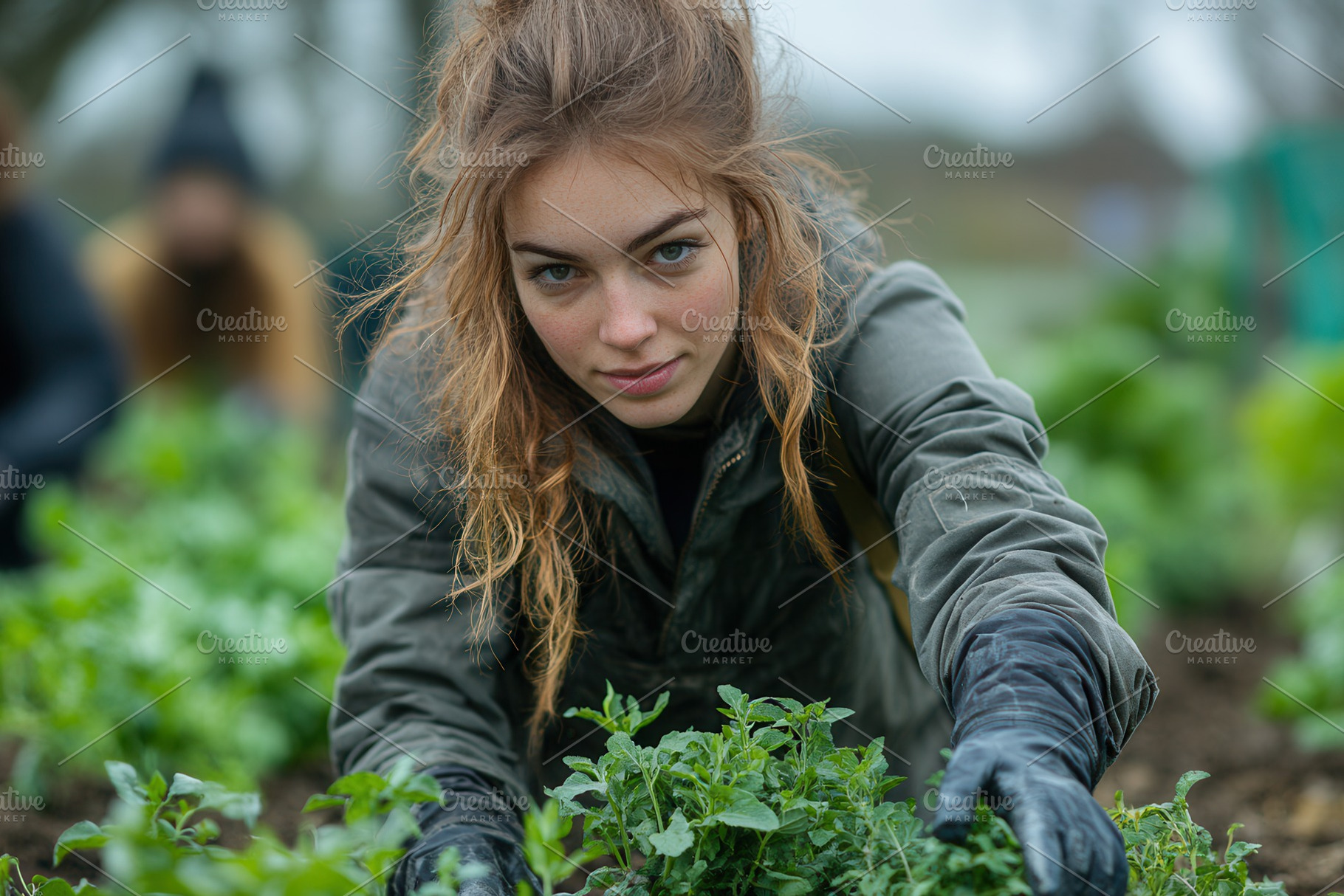Young woman gardening in a community, a Photo by Tanuart