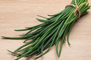 Fresh green chives tied with rustic twine, a Food & Drink Photo by Olena Rudo