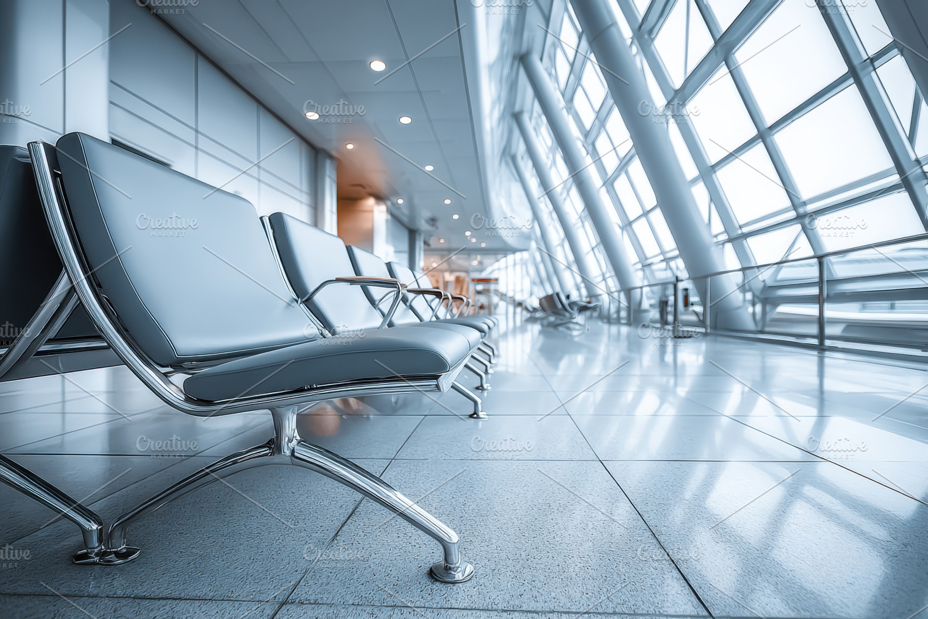 Modern airport interior with sleek seating and large windows, an Architecture Photo by AlyaAnd