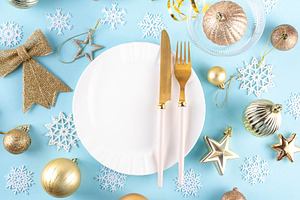Christmas, New Year table setting with plate, drinking glass, cu