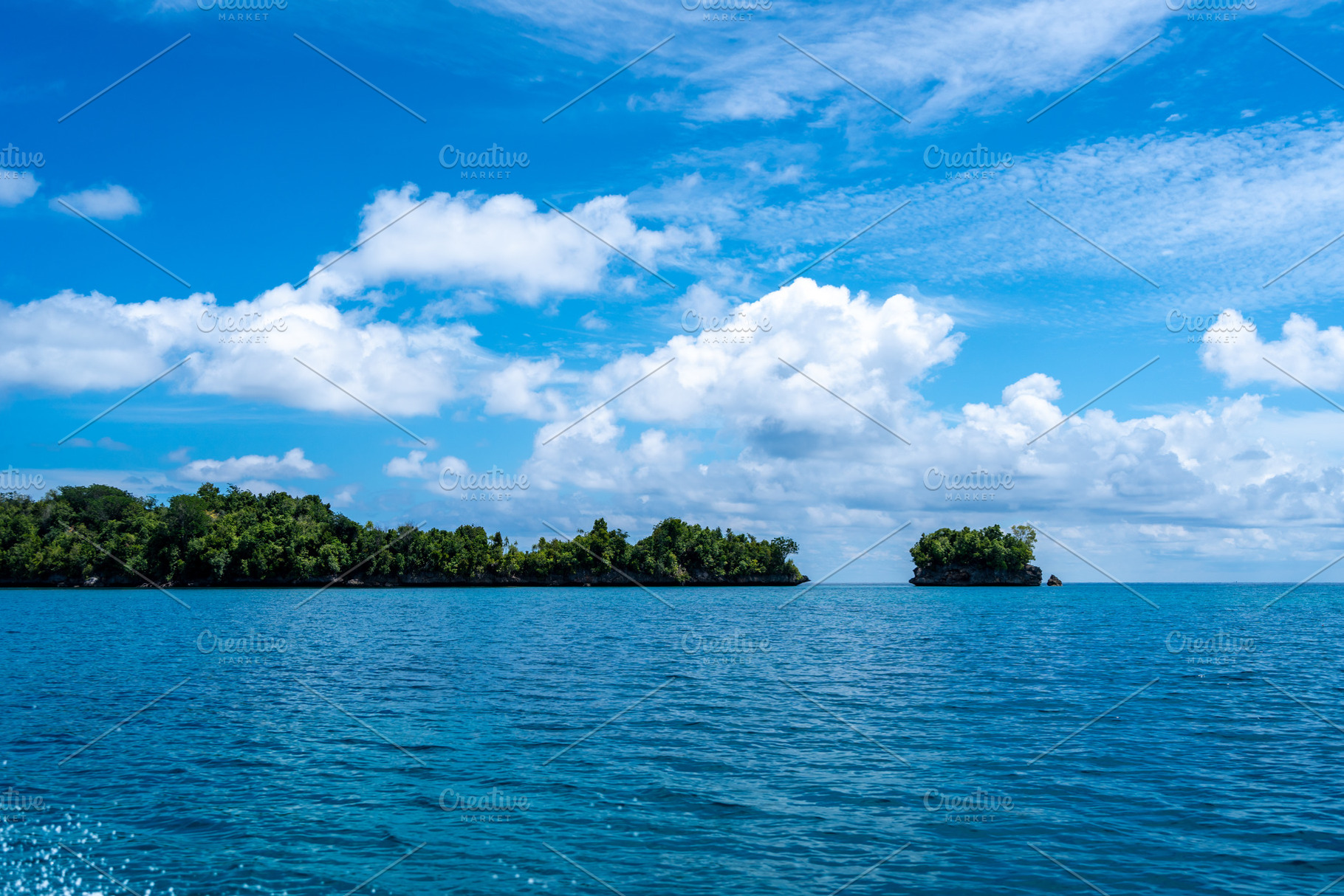 Rocky islets under blue sky, Togian Islands, Sulawesi, Indonesia, a Nature Photo by GoodGoods