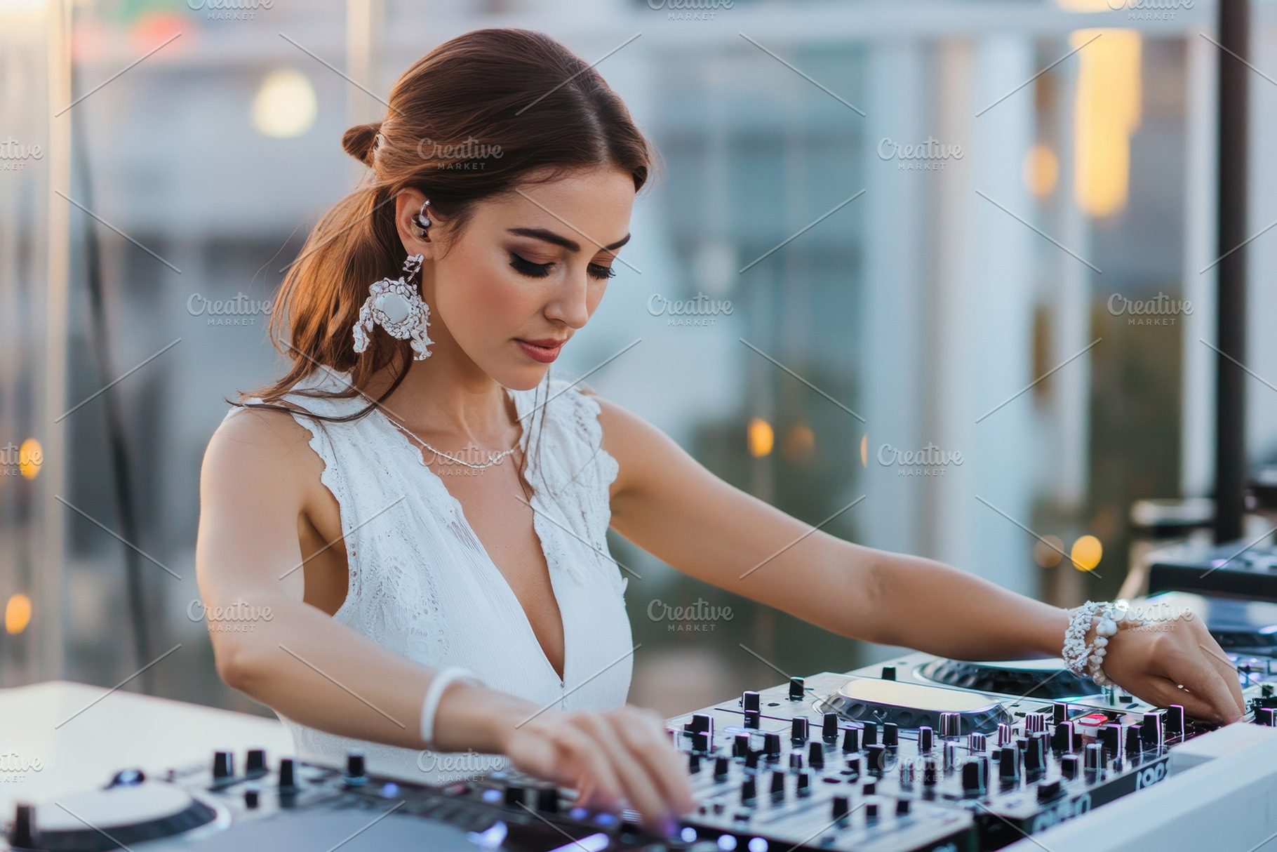 Young female DJ performing at a roof, a Photo by Tanuart