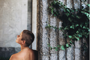 Person looking up near stone wall, a Beauty & Fashion Photo by Anna Efetova
