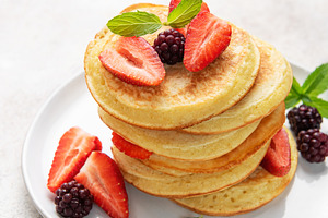 Stack of pancakes with fresh berries and mint, a Food & Drink Photo by Olena Rudo