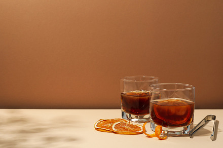 Concept of delicious alcohol drink, Whiskey with orange, a Food & Drink Photo by AtlasStudio PRO