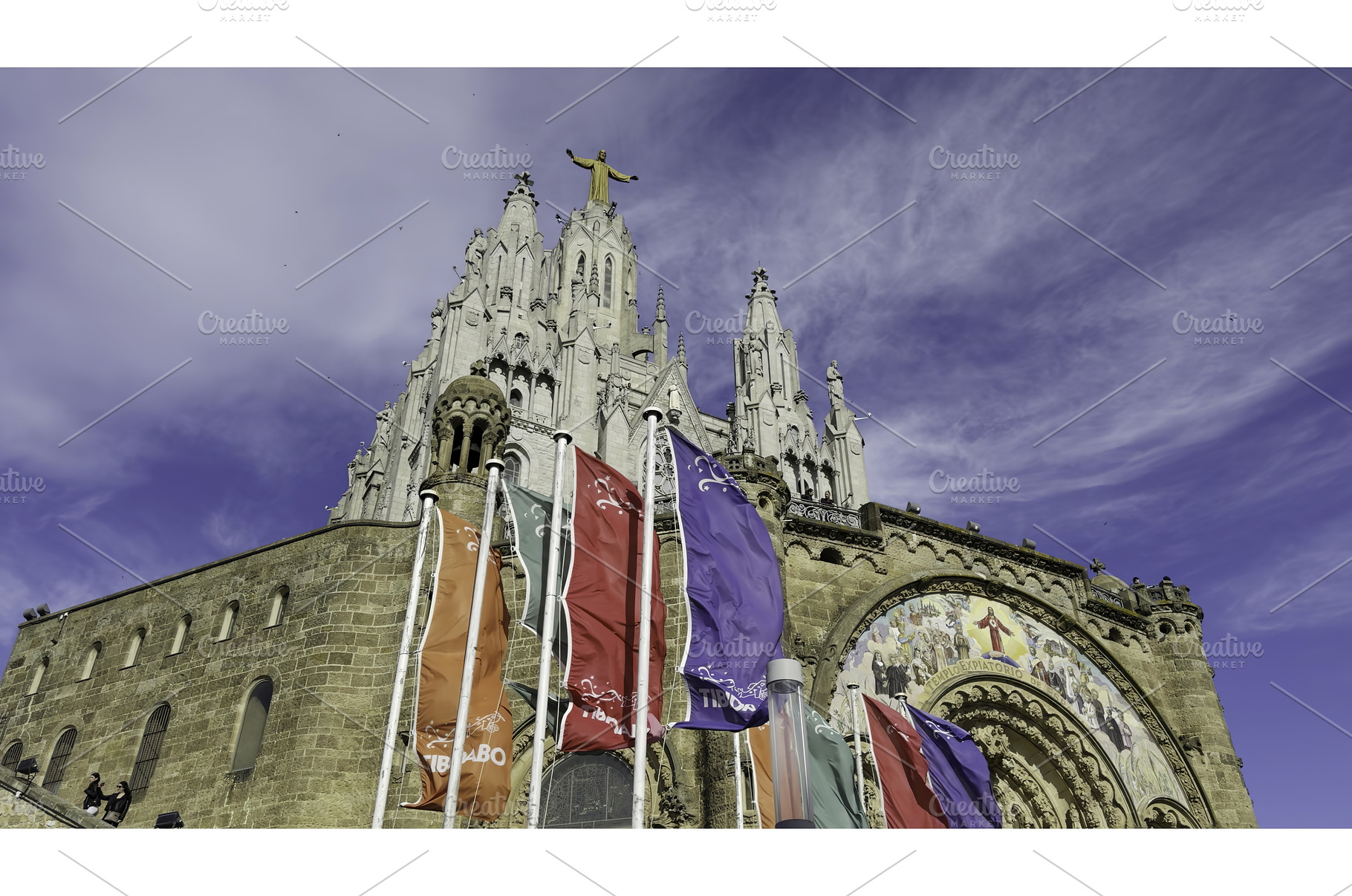Colorful flags waving at tibidabo, an Architecture Photo by Media Whale Stock