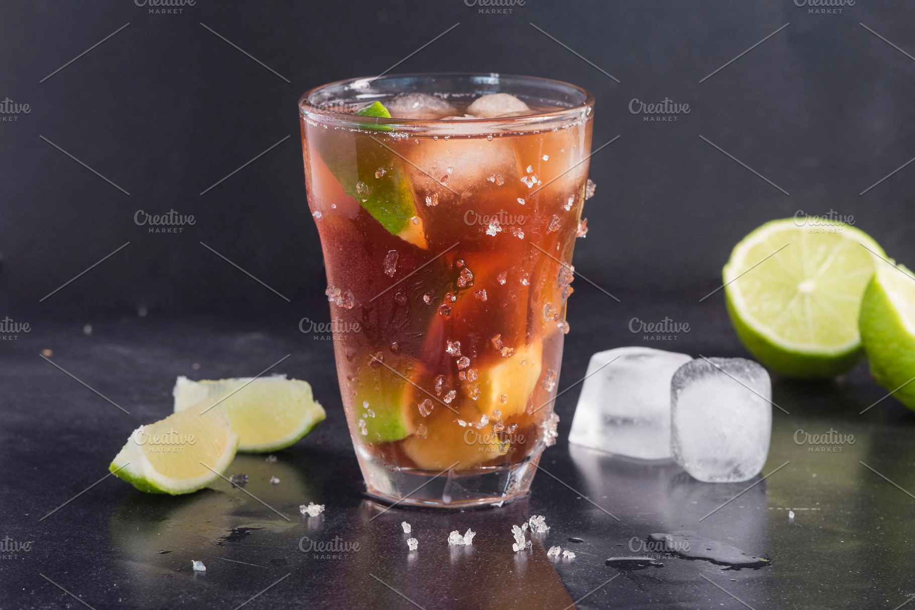 Rum cola cocktail on dark background, a Food & Drink Photo by DalaiFood
