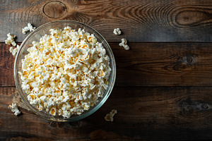 Popcorn on wood color background.Food and snack concepts ideas.Minimal style to, a Food & Drink Photo by Budarinphoto