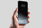 Hand Holding Smartphone Mockup PSD, an iPhone Mockup by graphypix (Thumbnail 1 of 4)
