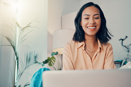Business woman, remote work home and smile being happy, with laptop and planning for startup company. Female entrepreneur, girl working and confident for strategy, digital device and online research, a Photo by Peopleimages.com