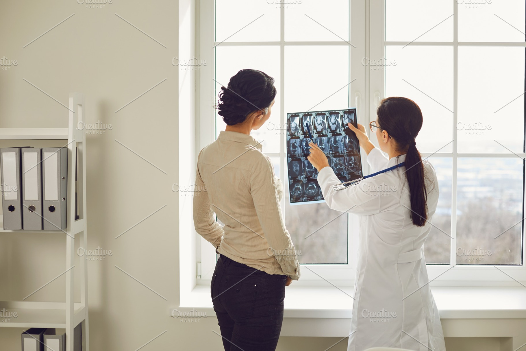 Doctor woman with xray talking containing woman, doctor, and x-ray, a Health & Medical Photo by StudioRomantic