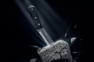 Kitchen knife embedded in rock strength determination, a Background Photo by DanFLCreativo