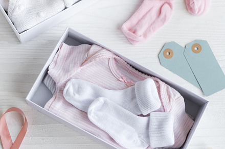 Box with baby stuff and accessories for newborn on white wooden, a Beauty & Fashion Photo by Olena Rudo