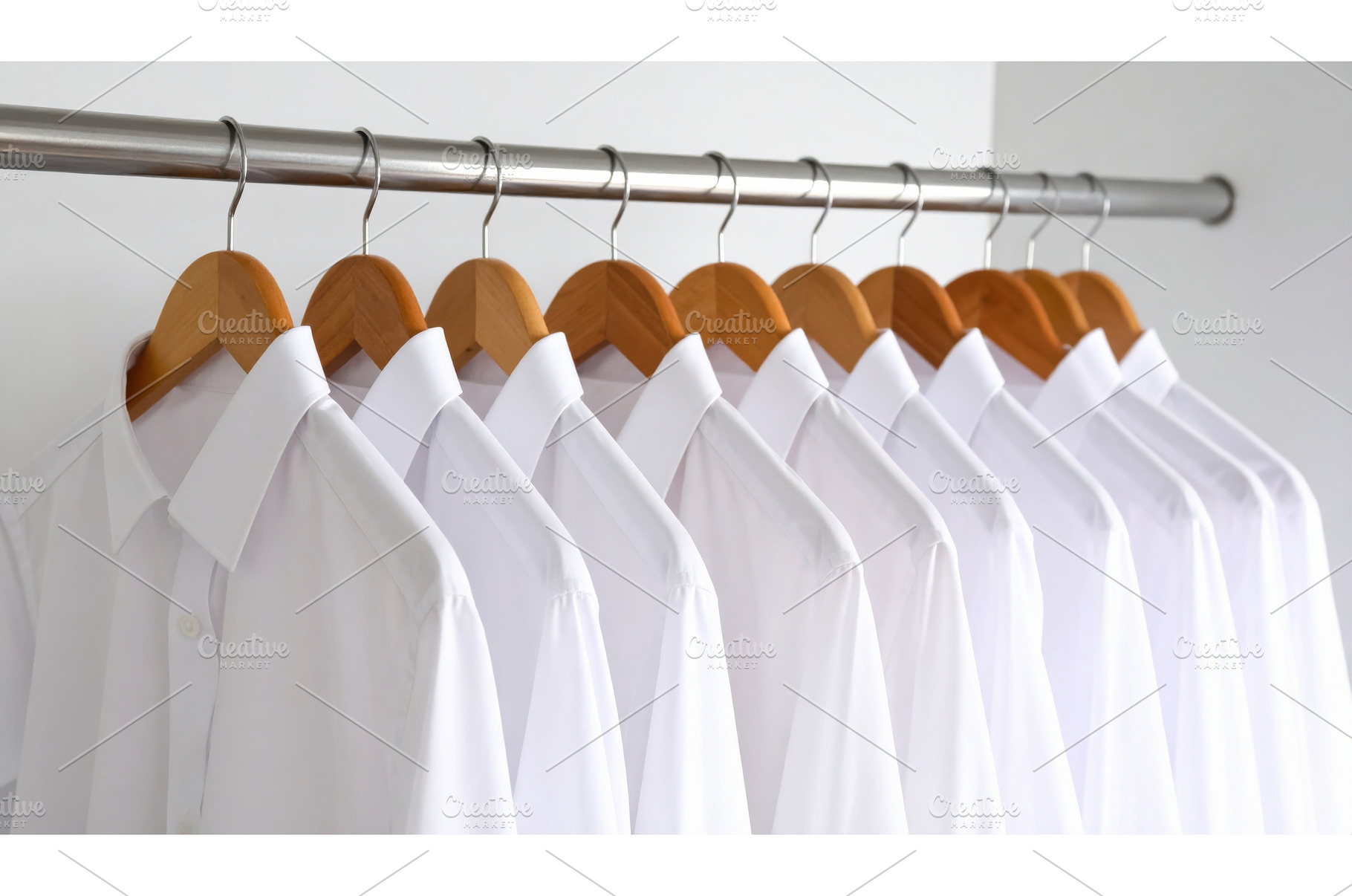 Row of neatly arranged white shirts, a Beauty & Fashion Photo by Igor Tichonow