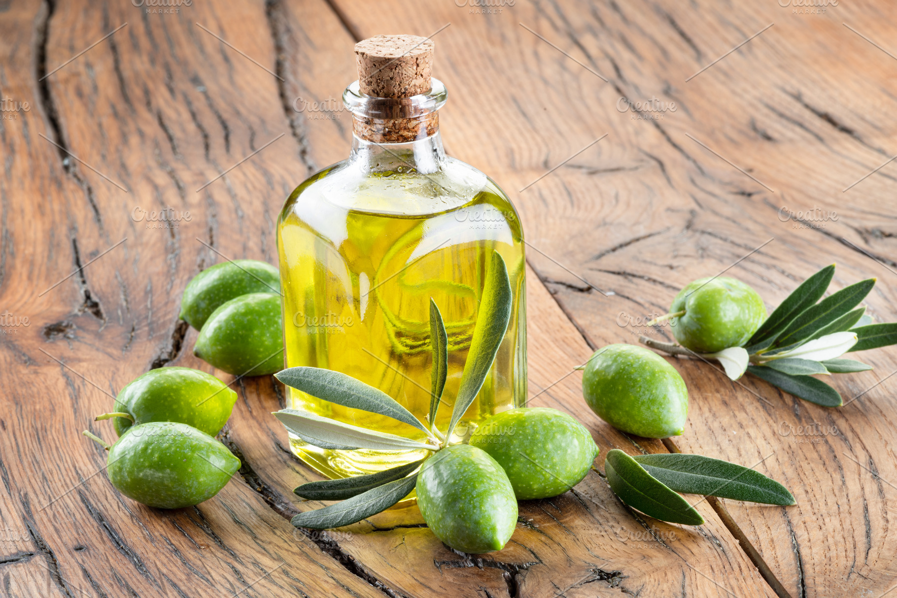 Green natural olives with bottle of olive oil on a vintage old w, a Food & Drink Photo by Volff