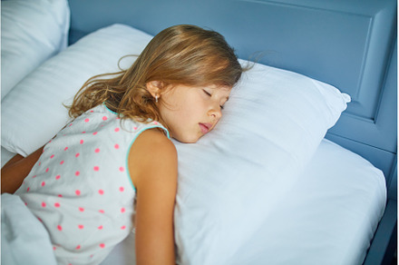 Little girl sleeping on a big and, a Person Photo by IlliaBondarPhotography