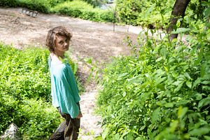 A young woman with curly hair and a, a Person Photo by Imaginarium