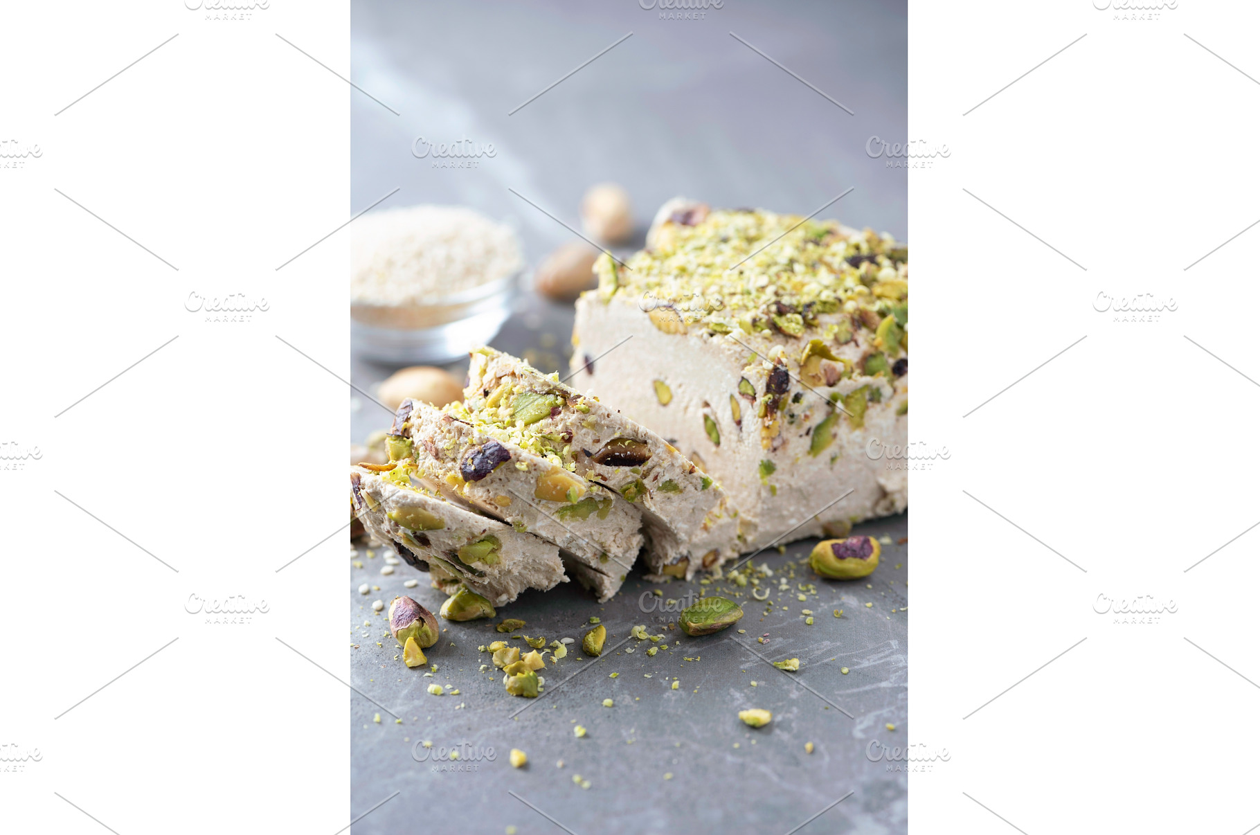 Sesame halva with pistachios on grey, a Food & Drink Photo by Enjoy Photo