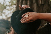 Woman with hands on her hat, a Person Photo by Wild Wander Collective (Thumbnail 1 of 2)
