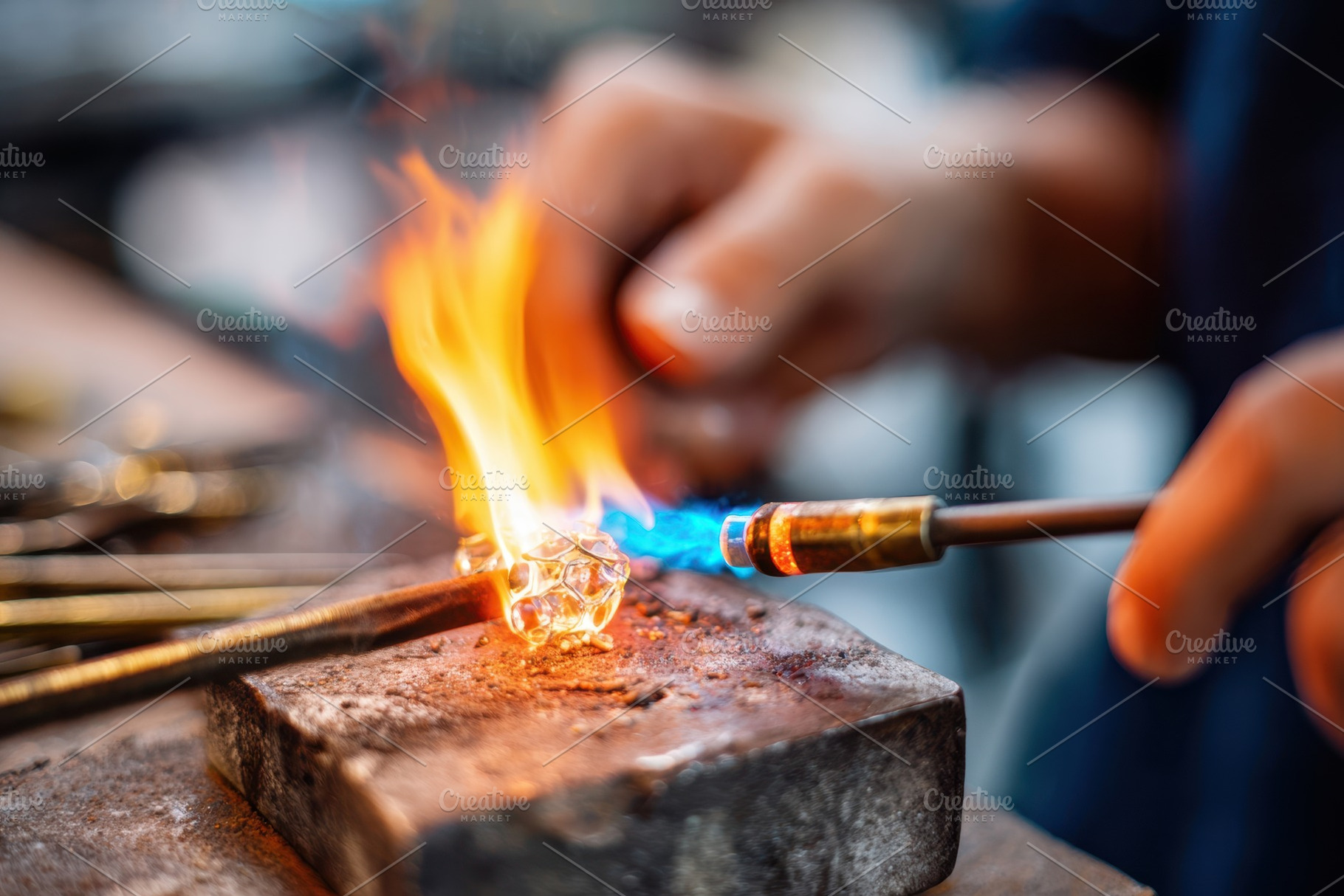 Artisan heating glass with torch, an Industrial Photo by AlyaAnd