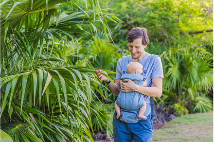 Young father walks in nature with