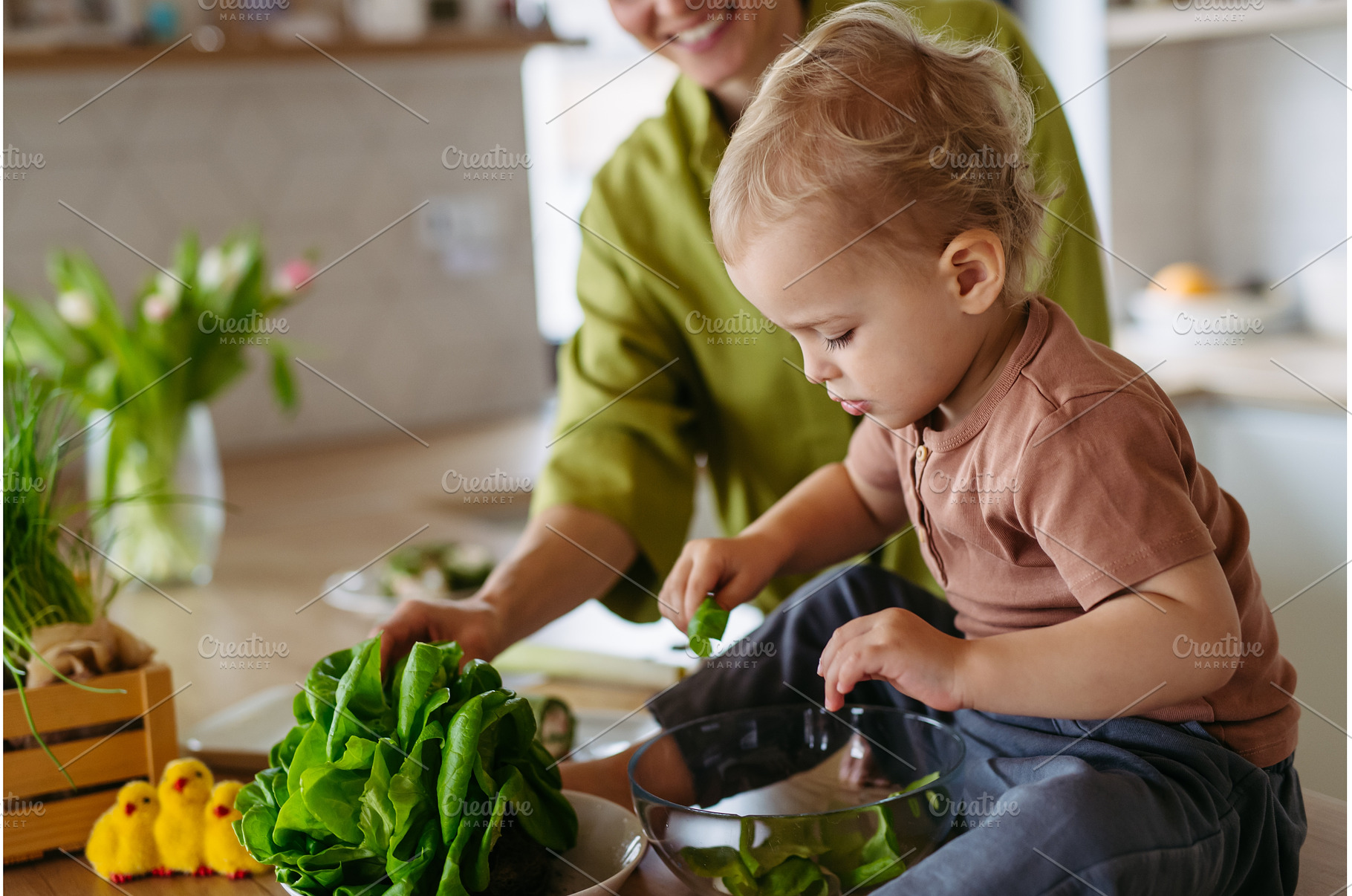 Mom and little boy preparing lettuce, a Food & Drink Photo by HalfPoint